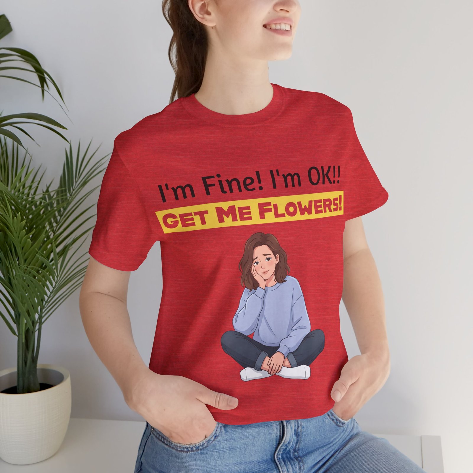 Woman wearing a red 'I'm Fine! I'm OK!! Get Me Flowers!' funny t-shirt with an illustration of a girl.