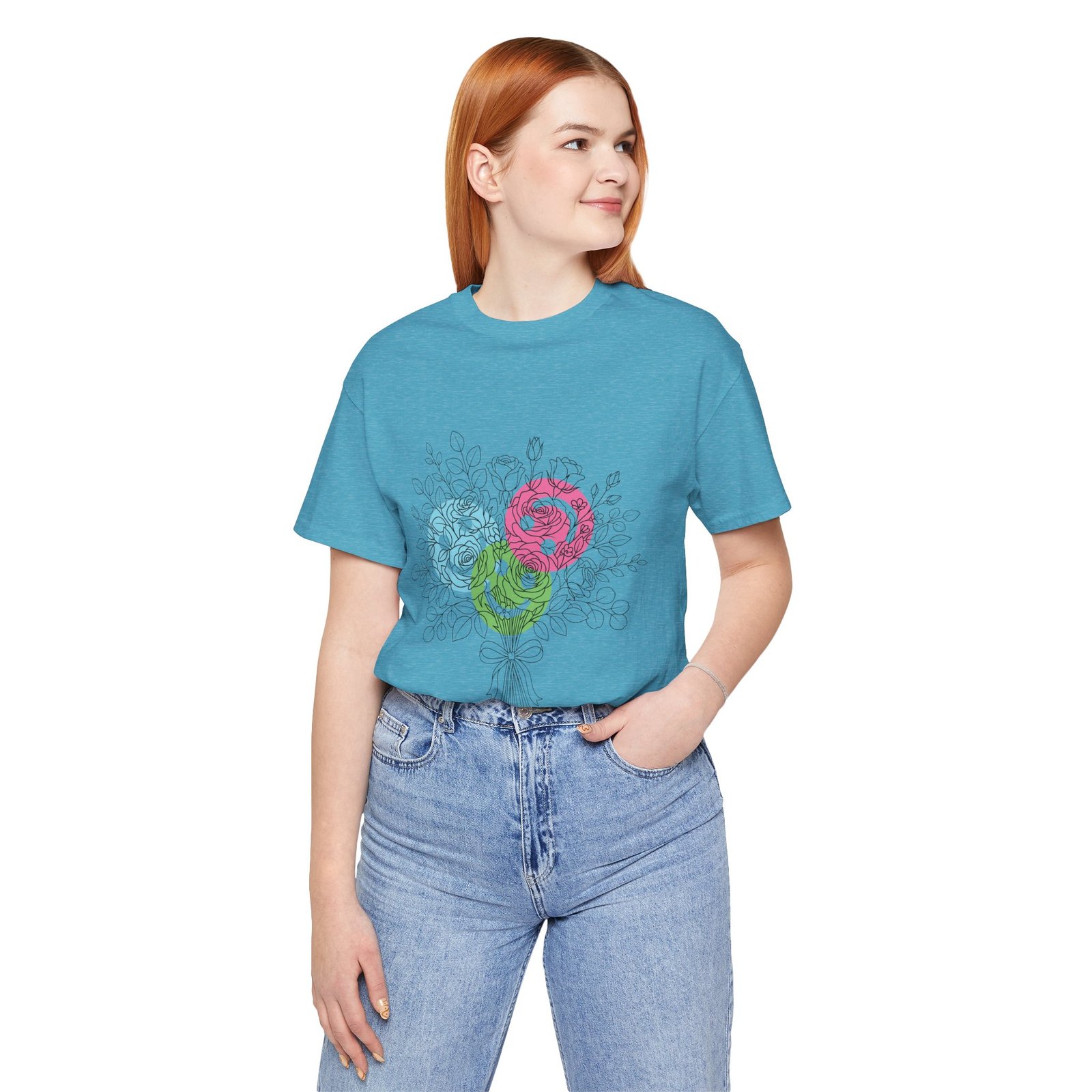 Woman wearing a teal crew neck T-shirt featuring a colorful floral bouquet design with teal, magenta, and lime blooms.