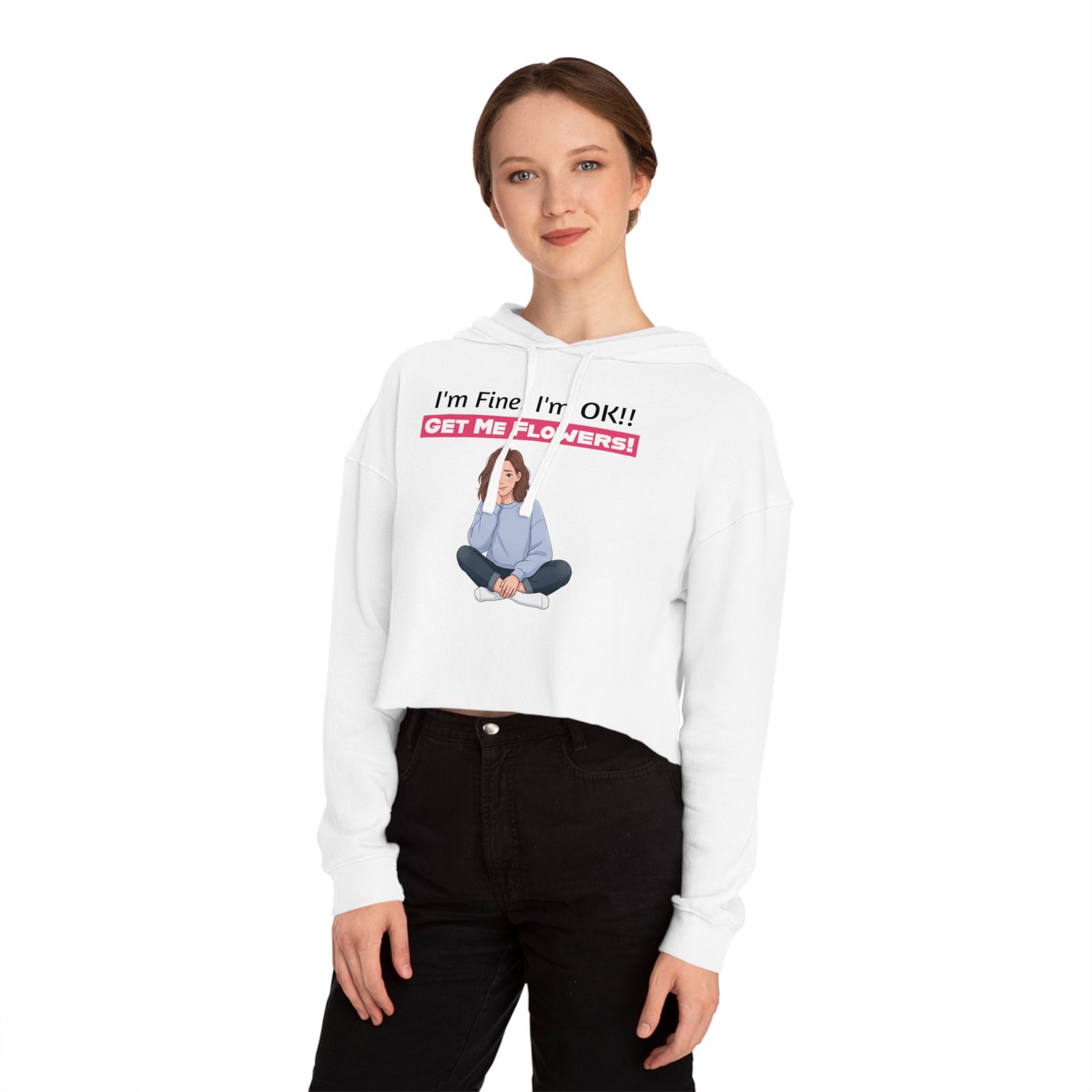 Woman wearing a white cropped hoodie with a graphic of a seated girl and text 'I'm Fine! I'm OK!! GET ME FLOWERS!'