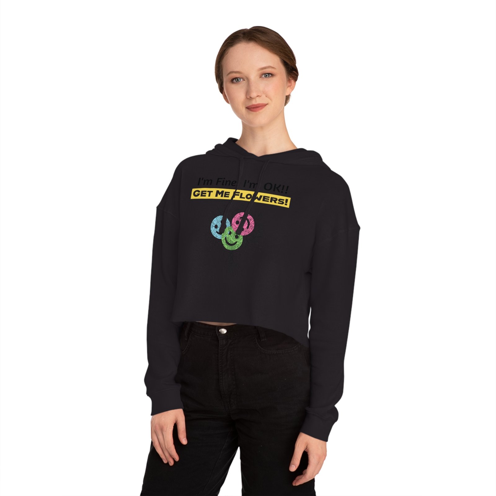 Woman wearing black cropped hoodie with 'I'm Fine! I'm OK!! GET ME FLOWERS!' yellow text and colorful floral graphic.