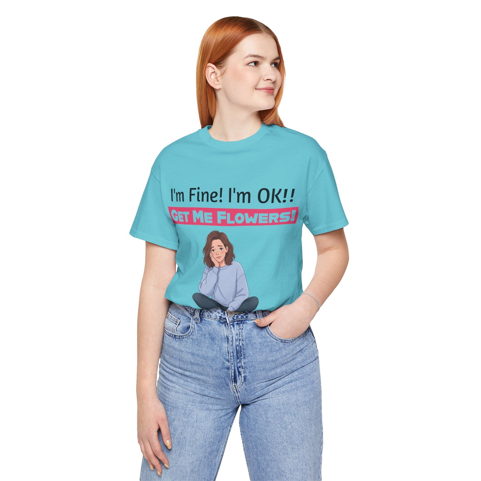 Woman wearing light blue funny t-shirt with 'I'm Fine! I'm OK!! GET ME FLOWERS!' graphic and cartoon illustration.